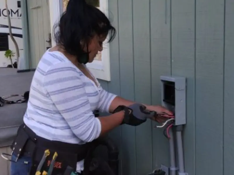 Licensed electrician wiring an exterior subpanel in Patton